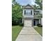 Two-story home with stone accents, a driveway, and a well-manicured lawn at 664 Oakside Pl, Acworth, GA 30102