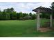 Lush green space with a swing and wooden structure that is perfect for relaxing at 664 Oakside Pl, Acworth, GA 30102