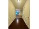 Hallway with wood floors and paneled walls leading to a carpeted living space at 664 Oakside Pl, Acworth, GA 30102