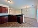 Kitchen with dark wood cabinets, stainless steel sink, and black countertops at 664 Oakside Pl, Acworth, GA 30102