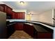 Open kitchen boasts dark cabinets, modern appliances, and seamless flow to the living area at 664 Oakside Pl, Acworth, GA 30102