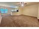 Large carpeted living room with a kitchen bar area and neutral wall color at 664 Oakside Pl, Acworth, GA 30102