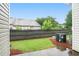 Fenced backyard with green grass, mature trees, and an air conditioning unit against the home at 2709 Heathrow Dr, Lawrenceville, GA 30043