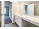 Bathroom sink with a large mirror, white cabinets and a view into an adjacent bedroom at 2709 Heathrow Dr, Lawrenceville, GA 30043