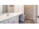 Well-lit bathroom with a white vanity, modern countertop, and a shower in the background at 2709 Heathrow Dr, Lawrenceville, GA 30043