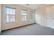 Well-lit bedroom with neutral walls, plush carpeting, and three windows offering a view of the neighborhood at 2709 Heathrow Dr, Lawrenceville, GA 30043