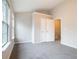Spacious bedroom with neutral walls, plush carpeting, and a closet, offering ample storage space at 2709 Heathrow Dr, Lawrenceville, GA 30043