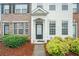 Charming townhouse with white siding, brick accents, well-kept landscaping, and a welcoming front door at 2709 Heathrow Dr, Lawrenceville, GA 30043