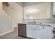Kitchen area showcasing white cabinets, stainless steel dishwasher, and sink with a view to the living room at 2709 Heathrow Dr, Lawrenceville, GA 30043