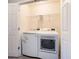 Laundry room featuring modern washer and dryer units and wire shelving for storage at 2709 Heathrow Dr, Lawrenceville, GA 30043