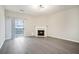 Bright living room featuring a fireplace, wood floors, and sliding glass doors to the backyard at 2709 Heathrow Dr, Lawrenceville, GA 30043