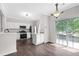 Bright kitchen with stainless steel appliances, granite countertops, and a sliding glass door leading to the deck at 2754 Terrell Trace Dr, Marietta, GA 30067