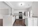 Modern kitchen featuring stainless steel appliances, granite countertops, and stylish white cabinetry at 2754 Terrell Trace Dr, Marietta, GA 30067