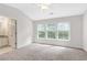 Light-filled main bedroom with carpet, vaulted ceiling, ceiling fan, and en suite bathroom at 2754 Terrell Trace Dr, Marietta, GA 30067