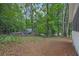 View of a wooded backyard with a shed and pool partially visible in the background at 5666 Fawn Dr, Powder Springs, GA 30127