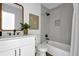Modern bathroom with a white vanity, a tub shower, custom tile work, and matte black fixtures at 5666 Fawn Dr, Powder Springs, GA 30127