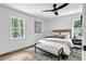 Bright bedroom with a neutral color scheme, modern ceiling fan, and natural light from large windows at 5666 Fawn Dr, Powder Springs, GA 30127