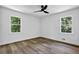 This bedroom has lots of light with two windows and features wood-look flooring and a ceiling fan at 5666 Fawn Dr, Powder Springs, GA 30127