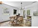 Bright dining room featuring modern lighting, wood floors, neutral walls, and a view to the outdoors at 5666 Fawn Dr, Powder Springs, GA 30127