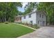 Bright home with an attached garage, lush lawn, and vibrant landscaping adding curb appeal at 5666 Fawn Dr, Powder Springs, GA 30127