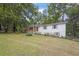 Charming home featuring a well-maintained lawn and inviting front porch with wooded surroundings at 5666 Fawn Dr, Powder Springs, GA 30127