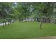 Landscaped front yard with mature trees and a green lawn at 5666 Fawn Dr, Powder Springs, GA 30127