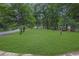 Lush front lawn with mature trees lining the street at 5666 Fawn Dr, Powder Springs, GA 30127