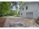 Attached two-car garage featuring white painted brick and a concrete driveway at 5666 Fawn Dr, Powder Springs, GA 30127