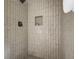 Walk-in shower with custom tile work, a niche, and matte black fixtures in a modern bathroom at 5666 Fawn Dr, Powder Springs, GA 30127