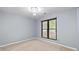 Bright bedroom featuring a large window with outside views at 9383 Woodknoll Way, Jonesboro, GA 30238