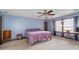Bedroom featuring blue painted walls, carpeted floor, a ceiling fan, and a window at 9383 Woodknoll Way, Jonesboro, GA 30238