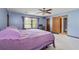 This bedroom has blue painted walls, carpeted floors, and a window at 9383 Woodknoll Way, Jonesboro, GA 30238
