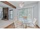 View of the dining room area, featuring a glass table and a fireplace at 9383 Woodknoll Way, Jonesboro, GA 30238