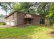 Charming home with wood siding, stone accents, and a two-car garage surrounded by lush greenery at 9383 Woodknoll Way, Jonesboro, GA 30238