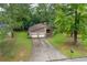 Lovely home exterior with a two-car garage, long driveway, and well-maintained front yard at 9383 Woodknoll Way, Jonesboro, GA 30238