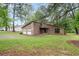 Charming home with wood siding and stone accents, complemented by a neatly kept front lawn at 9383 Woodknoll Way, Jonesboro, GA 30238