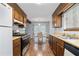 Galley kitchen featuring wood cabinets and stainless steel appliances at 9383 Woodknoll Way, Jonesboro, GA 30238
