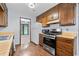 Kitchen featuring wood cabinets, stainless steel appliances and laminate countertop at 9383 Woodknoll Way, Jonesboro, GA 30238