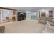 Open living room with fireplace, plush carpeting, and views into other rooms at 9383 Woodknoll Way, Jonesboro, GA 30238