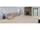 Bright living room featuring a cozy fireplace, plush carpet, and comfortable seating at 9383 Woodknoll Way, Jonesboro, GA 30238