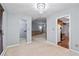 Open-concept living space with views into wet bar, Gathering room and kitchen at 9383 Woodknoll Way, Jonesboro, GA 30238