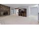Spacious living room with stone fireplace, vaulted ceiling, and plush carpeting at 9383 Woodknoll Way, Jonesboro, GA 30238