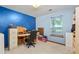 Office features a desk, neutral carpet, one window, and a blue accent wall at 9383 Woodknoll Way, Jonesboro, GA 30238