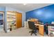 This room features a desk and chair setup and blue accent wall at 9383 Woodknoll Way, Jonesboro, GA 30238