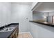 View of the wet bar with wood cabinets and laminate countertop at 9383 Woodknoll Way, Jonesboro, GA 30238