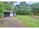 Spacious backyard with garage, carport, firepit, and plenty of room for outdoor activities at 122 Vickery Dr, Fairburn, GA 30213