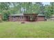 Brick home with a patio, firepit, and a large backyard perfect for entertaining at 122 Vickery Dr, Fairburn, GA 30213