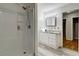 Updated bathroom featuring a shower, vanity, and hardwood floors at 122 Vickery Dr, Fairburn, GA 30213