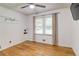 Bright bedroom with hardwood floors, a ceiling fan, and a window with neutral curtains at 122 Vickery Dr, Fairburn, GA 30213