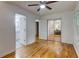 Bright bedroom with gleaming hardwood floors and mirrored closet doors at 122 Vickery Dr, Fairburn, GA 30213
